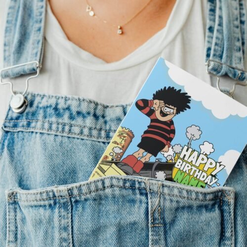 Personalised Dennis menace cannon birthday card template with 'Happy Birthday' text and space for a name, ideal for custom celebrations.