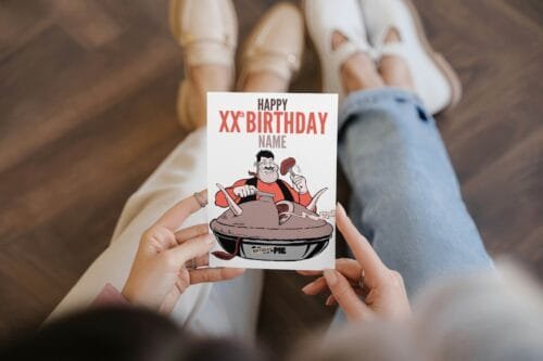 Person holding Desperate Dan birthday card featuring 'Happy Xth Birthday' text with space for name and birthday pie illustration