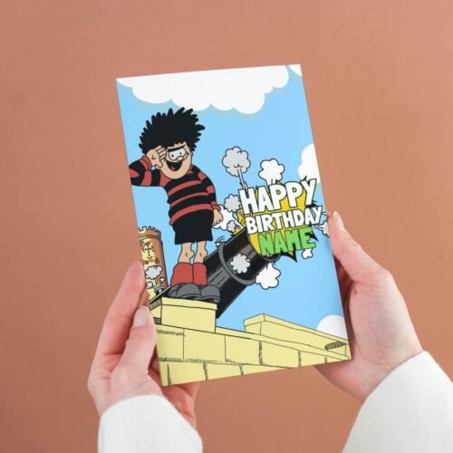 Personalised Dennis menace cannon birthday card template with 'Happy Birthday' text and space for a name, ideal for custom celebrations.
