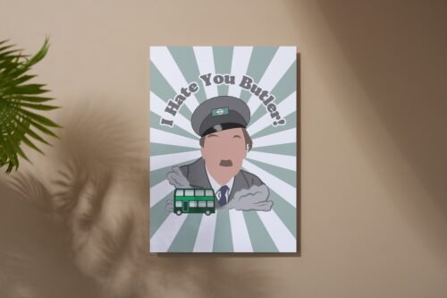 Screenshot of a customizable greeting card featuring the playful quote 'I hate you butler!' in bold, retro-style font, referencing the classic British sitcom On the Buses. The text is set against a plain or lightly textured background, evoking a humorous and nostalgic tone for fans of the show. This features the card upright on a table with a cartoon of character from the show Blake.