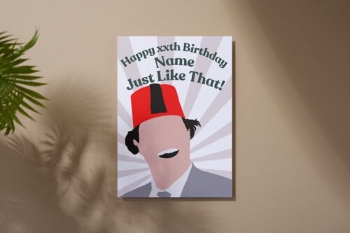 Overhead view of the card with bold illustration and “Just like that!” text on rustic surface