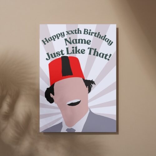 Overhead view of the card with bold illustration and “Just like that!” text on rustic surface