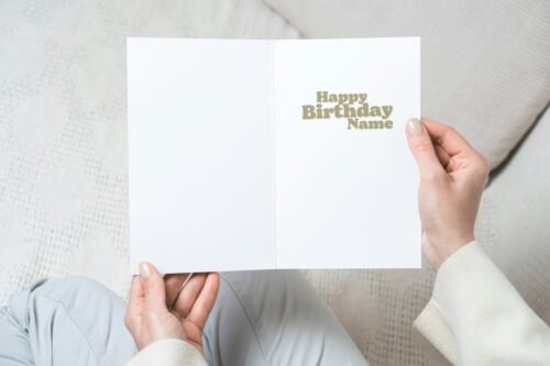 Close-up of the card in hand showing personalised name and age on the front