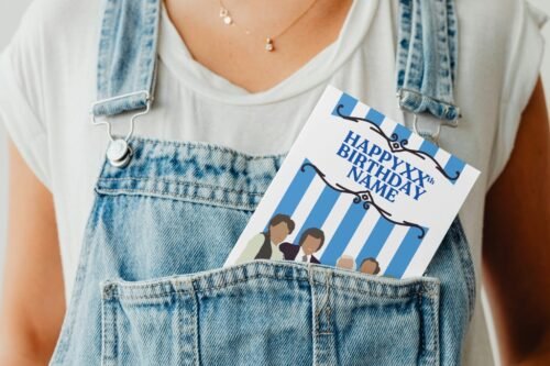 Funny greeting card peeking from a denim pocket in a playful display shot