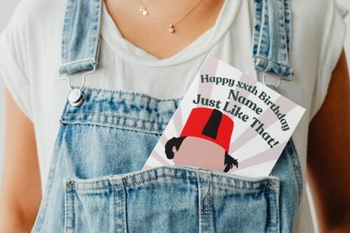 Tommy Cooper birthday card peeking out of a denim dungaree pocket in a playful display shot