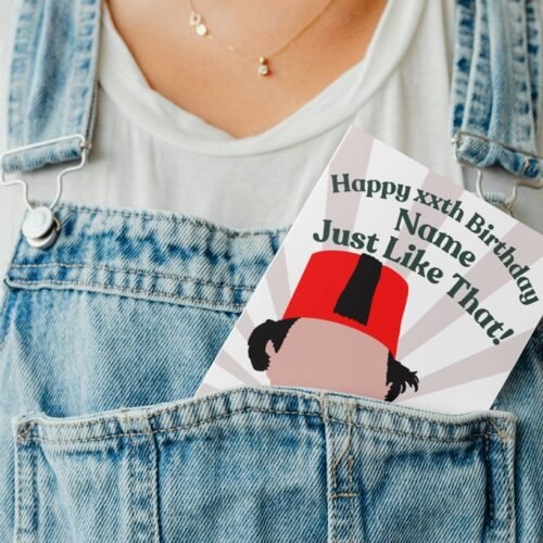 Tommy Cooper birthday card peeking out of a denim dungaree pocket in a playful display shot