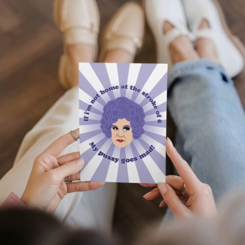 Person holding a Mrs Slocombe Pussy Card featuring her iconic quote and retro artwork