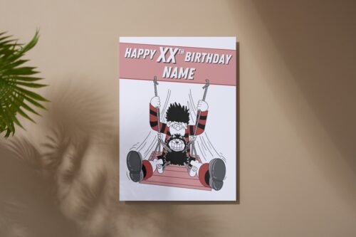 Dennis and Gnasher birthday card laid on table with bold red and black Beano colours