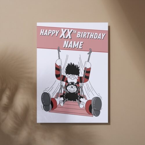 Dennis and Gnasher birthday card laid on table with bold red and black Beano colours