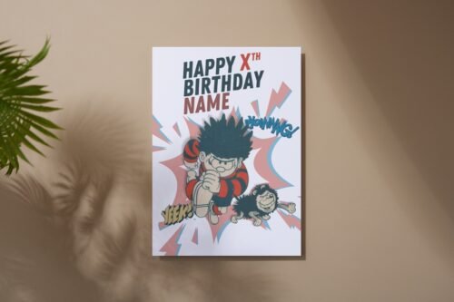 Dennis the Menace birthday card laid flat on a wooden table with name and age on the front