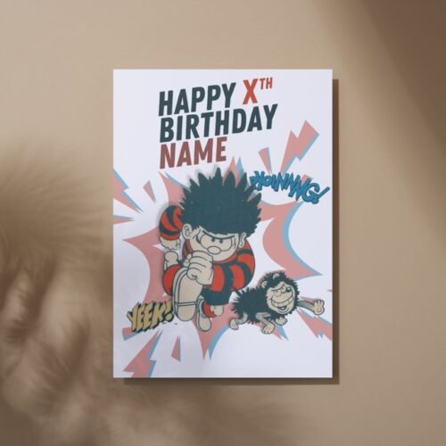 Dennis the Menace birthday card laid flat on a wooden table with name and age on the front