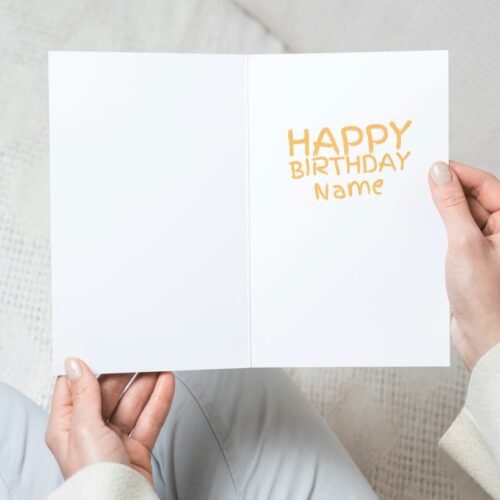 Close-up of Beano-style birthday card printed on matte cardstock, held in hand