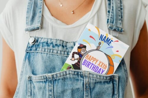 Personalised Beano-style birthday card peeking from denim pocket, adding playful touch