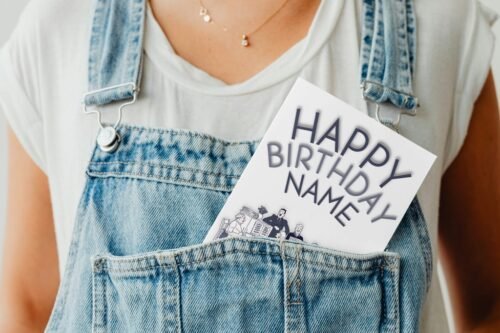 The Broons personalised birthday card partially tucked into a jacket pocket, showing a glimpse of the fun cartoon design and birthday message.