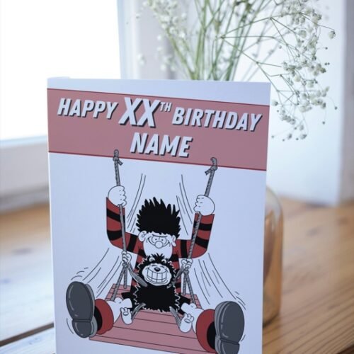 Comic-style card with name and age customisation, placed on wooden surface