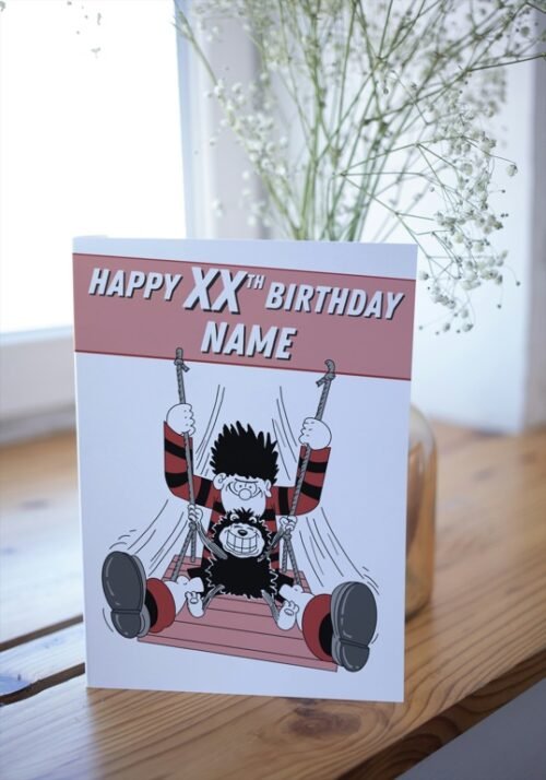 Comic-style card with name and age customisation, placed on wooden surface