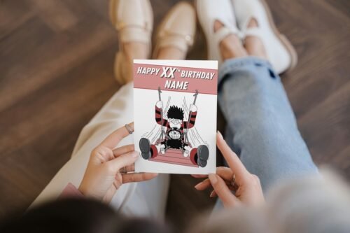 Dennis the Menace personalised birthday card with name and age on cover, held in hand