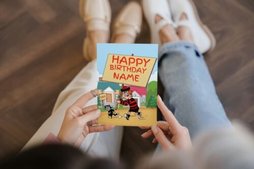 Comic birthday card featuring Minnie and her cat holding birthday signs