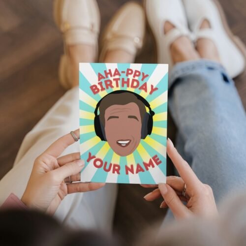 Premium birthday card held in hand with bold comedy design