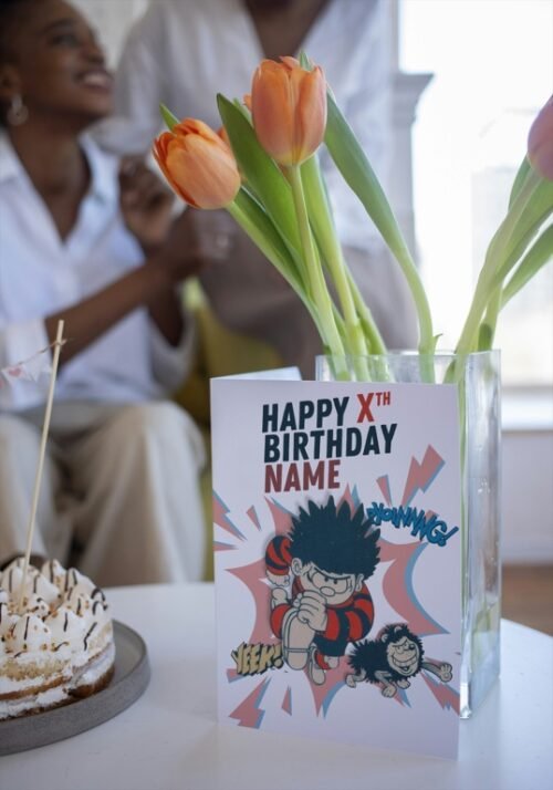 Comic-style personalised card showing Dennis and Gnasher jumping out with sound effects